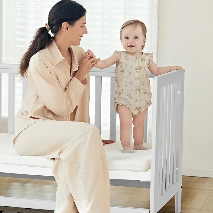 EvoNest Baby Crib, 6 in 1 Convertible Mini Crib with Wheels, 100% New Zealand Solid Wood Growing Bed, 4 Adjustable Mattress Height，White